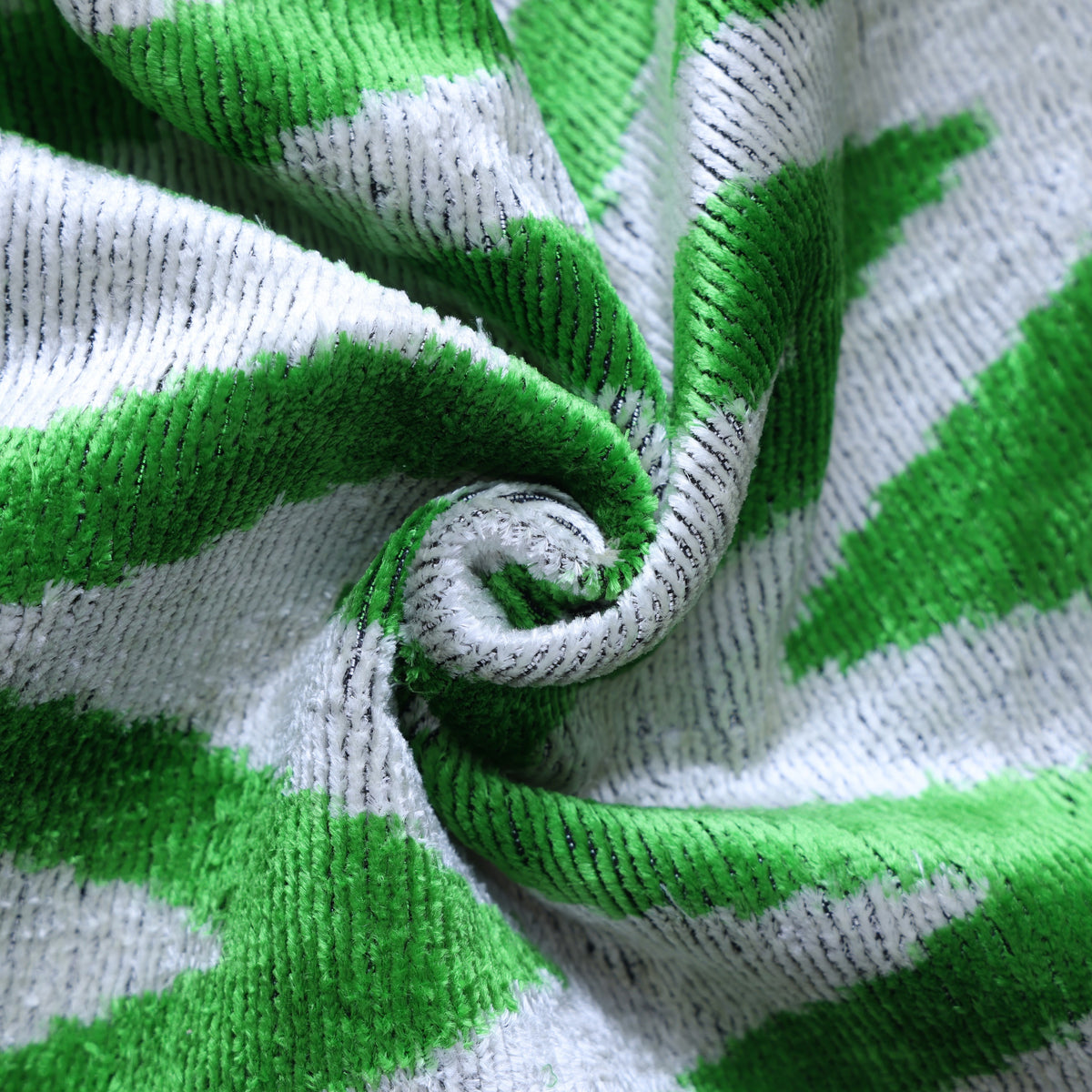 Swirled fold showing bright green and light gray velvet pile and sheen