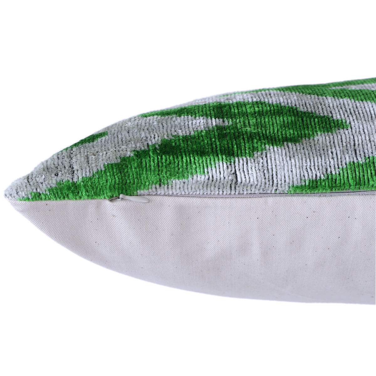 Bottom edge detail showing the hidden zipper on the green and gray pillow
