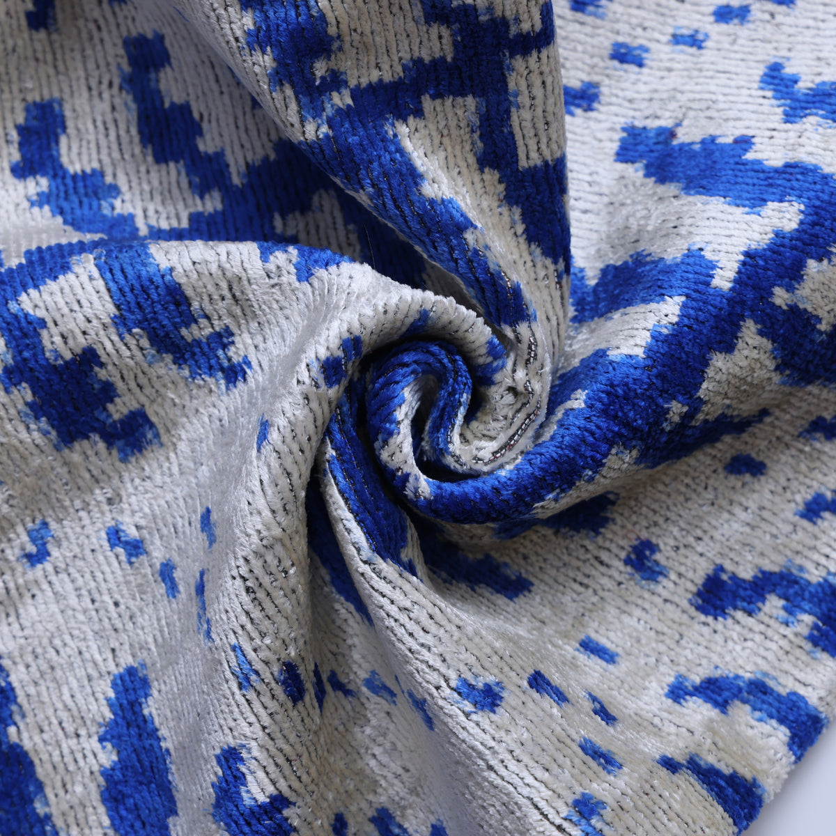 Swirled cobalt and silver gray velvet detail showing soft sheen and pile texture