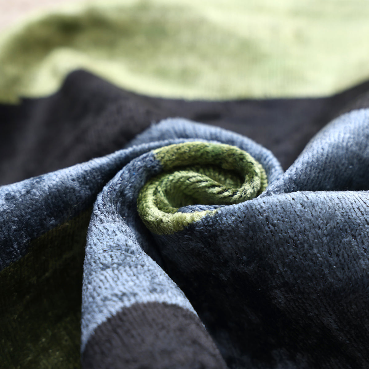 Rolled olive moss velvet showing plush texture and a soft lustrous sheen