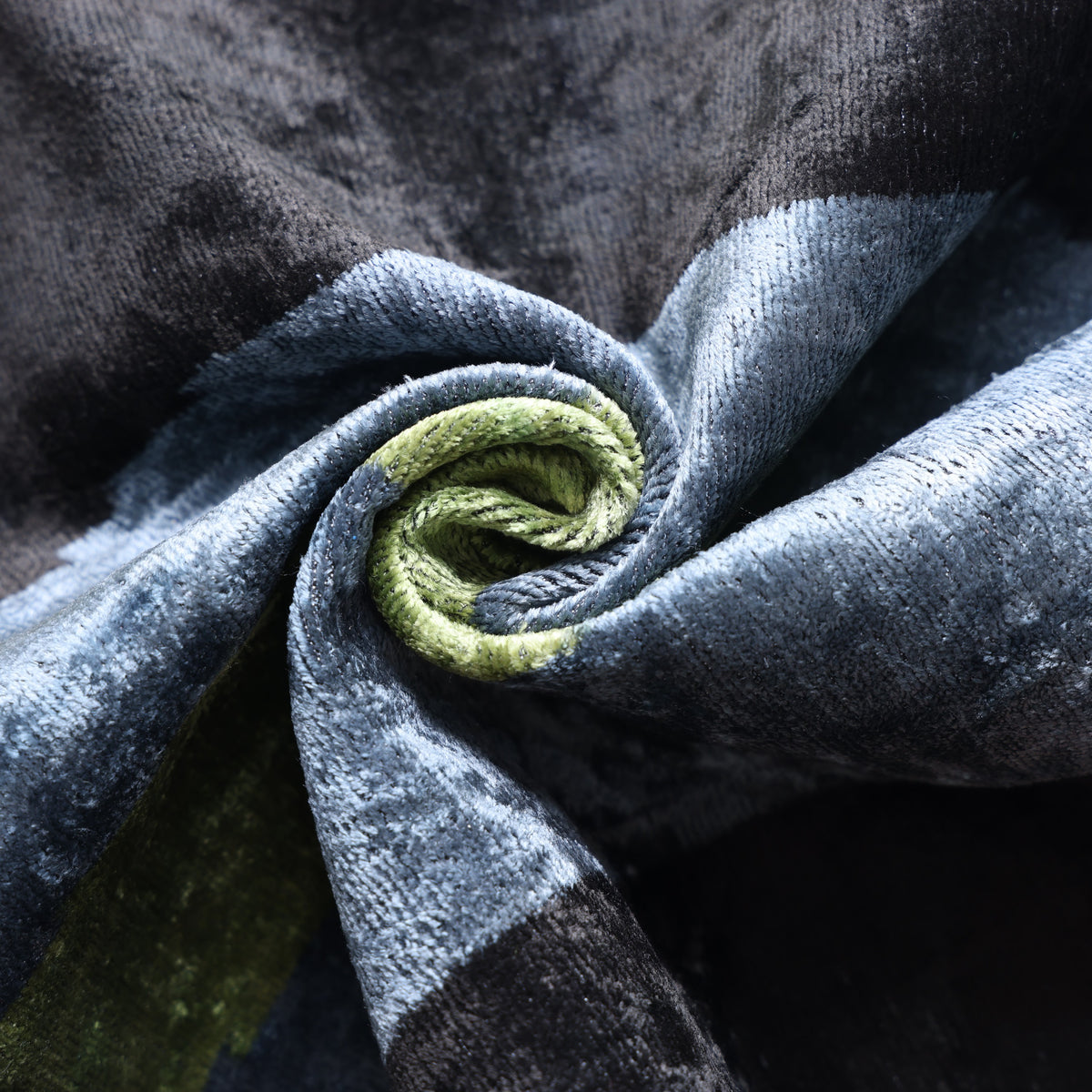 Folded velvet in olive moss, slate blue and inky black with visible plush folds