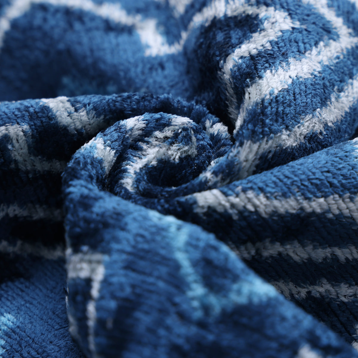 Folded medium denim blue silk velvet showing plush texture and soft sheen