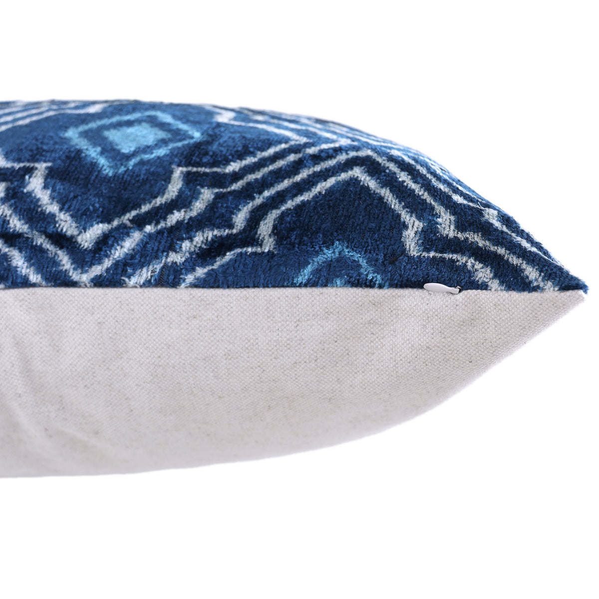 Bottom edge of blue velvet lumbar pillow with hidden zipper detail