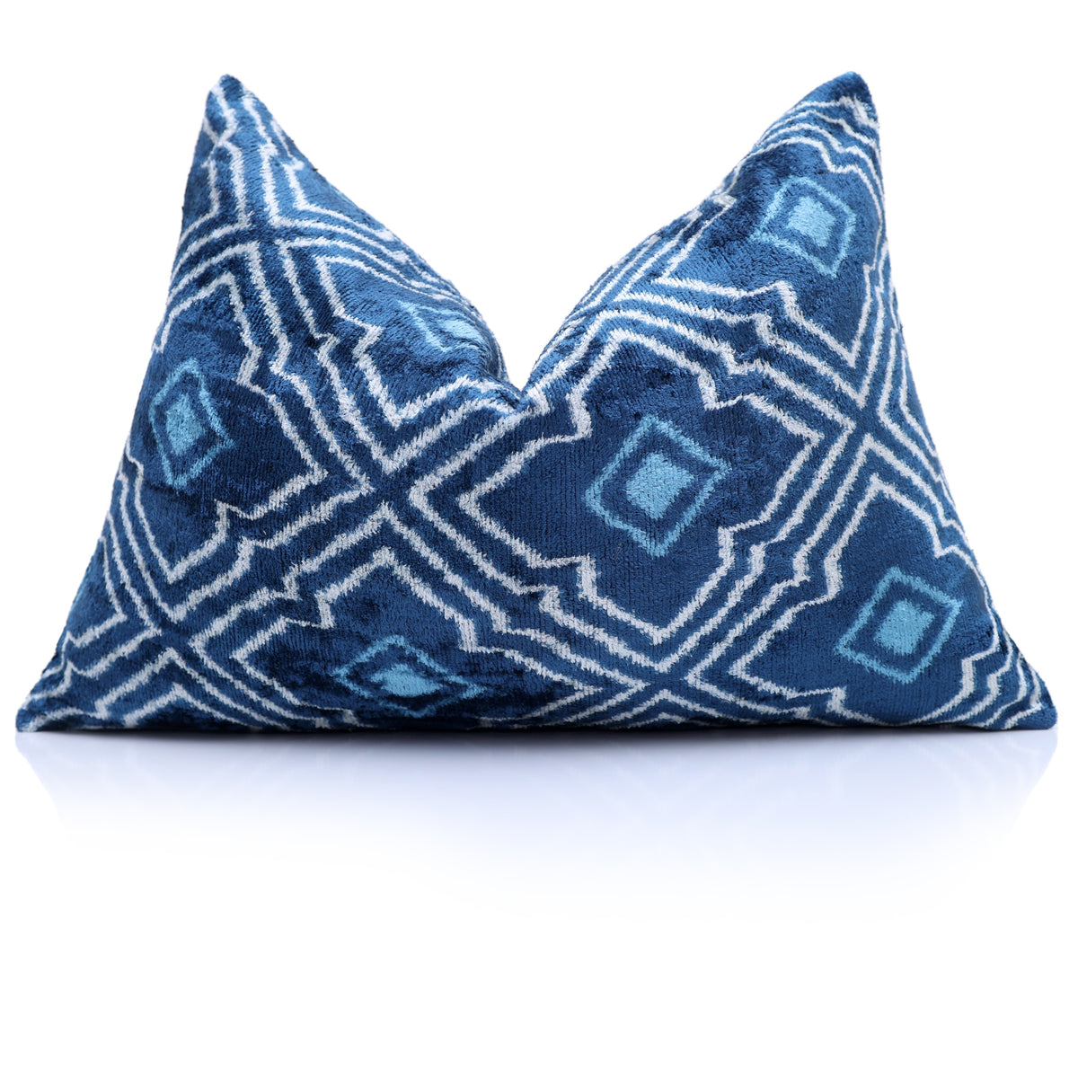 Medium denim blue and white geometric lumbar pillow styled with a center chop