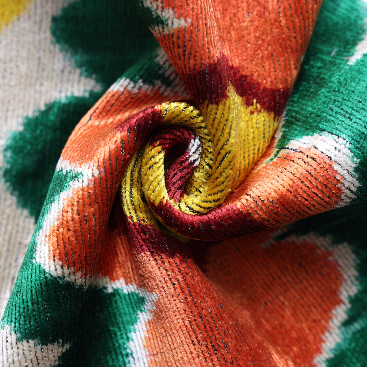 Close-up of silvery ivory and burgundy red swirled velvet showing lustrous texture