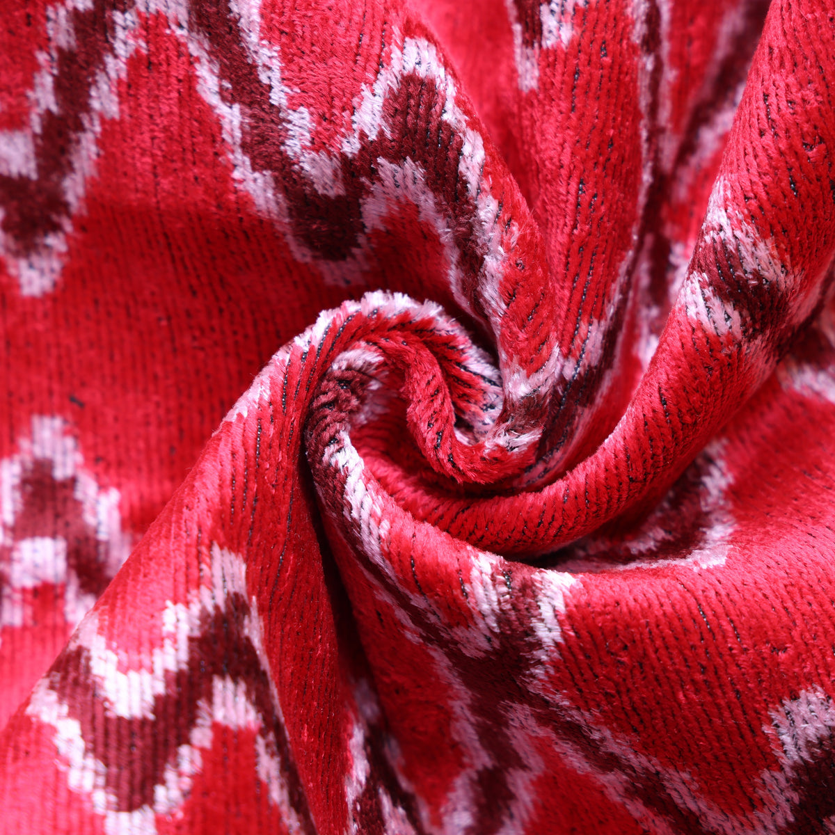 Close-up of cherry red silk velvet showing plush textured pile and subtle sheen