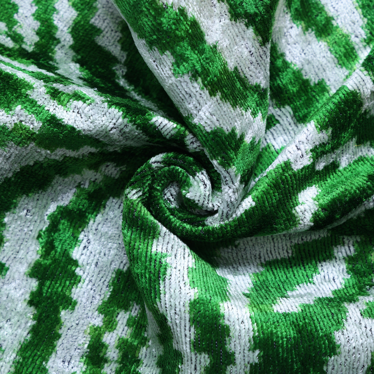 Close view of gathered emerald green and cool white zebra fabric texture.