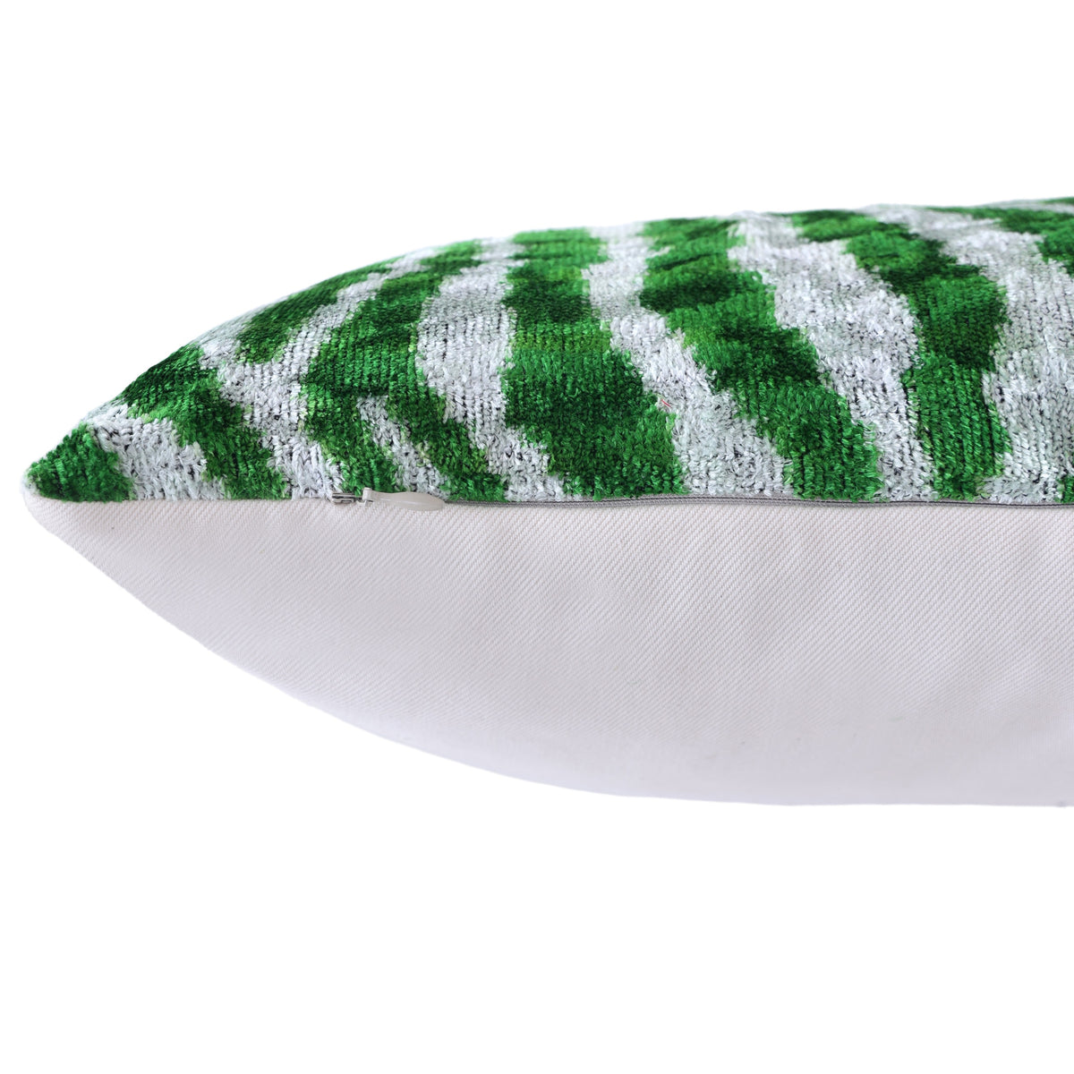 Hidden zipper closure along the seam of an emerald green and cool white zebra pillow.
