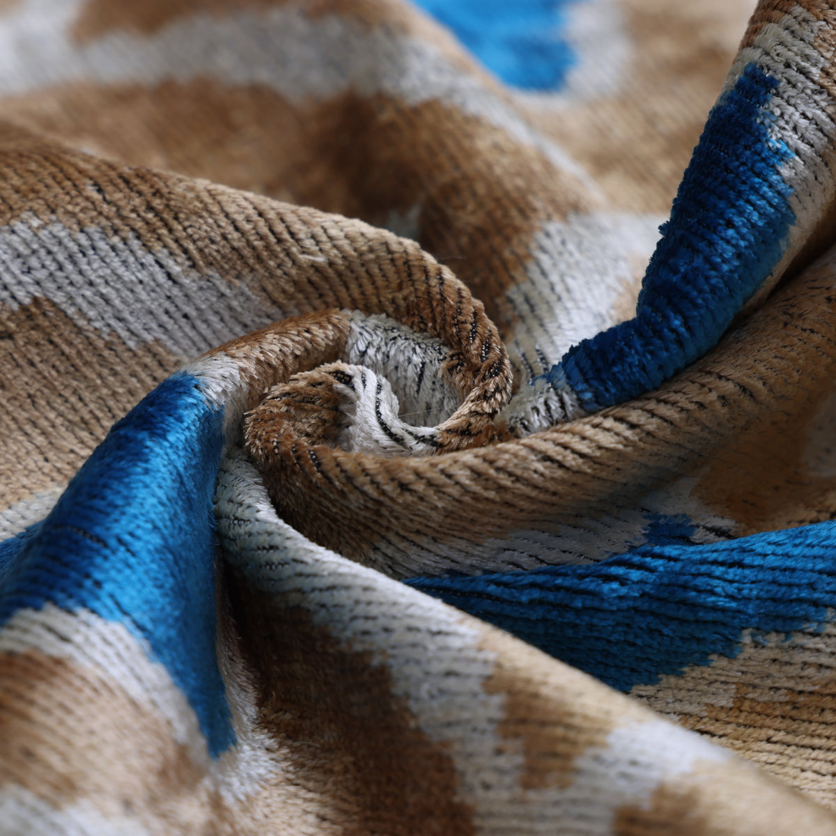 Plush golden taupe velvet folded to show texture and light-catching sheen
