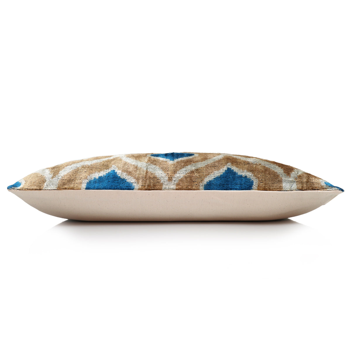 Side profile of geometric ikat lumbar pillow with plain linen backing