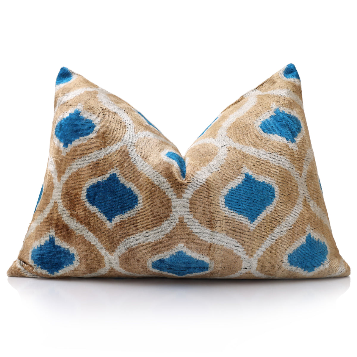 Geometric ikat lumbar pillow styled with a center chop on white background
