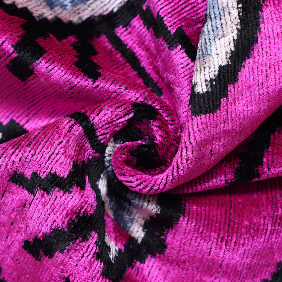 Close view of magenta pink silk velvet showing its luminous ribbed pile