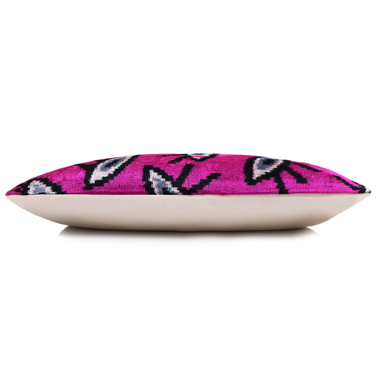 Side profile of the magenta pink lumbar pillow showing its thickness and backing