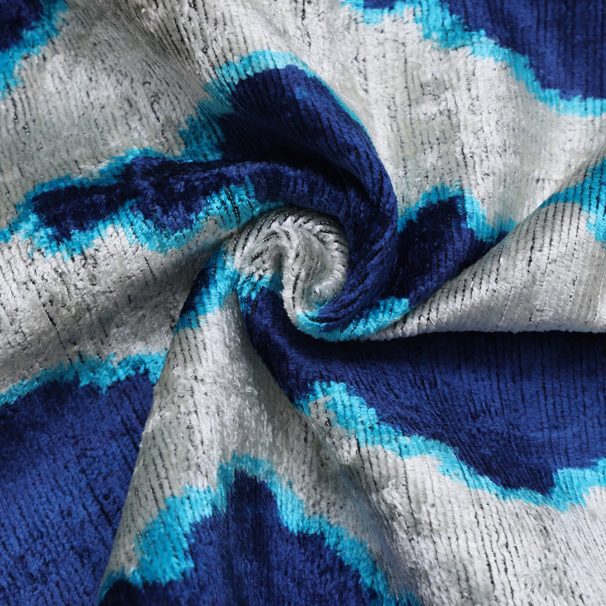 Crumpled silk velvet showing silvery white, cobalt royal blue, and bright turquoise blue luster