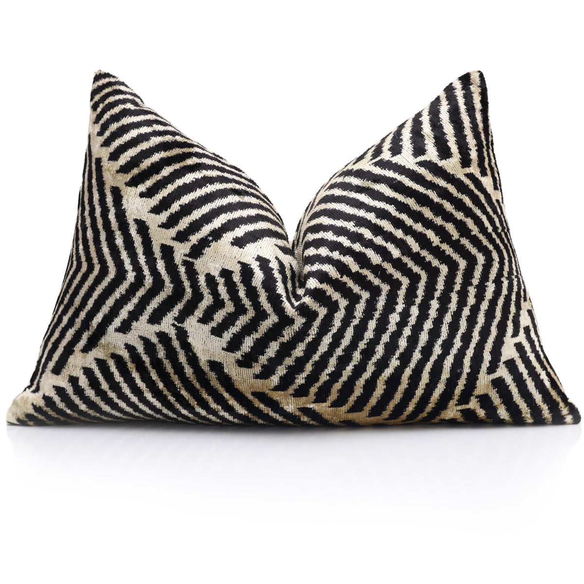 Styled jet black and champagne beige chevron lumbar pillow with a karate chop crease