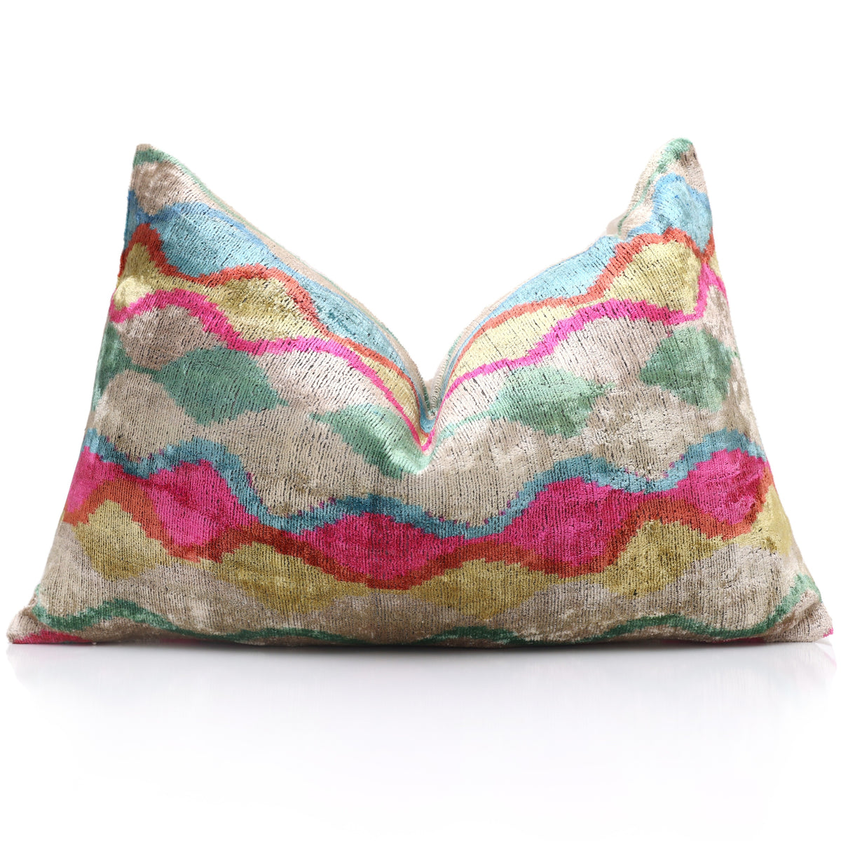 Wavy ikat lumbar pillow styled with a center chop on a reflective white surface