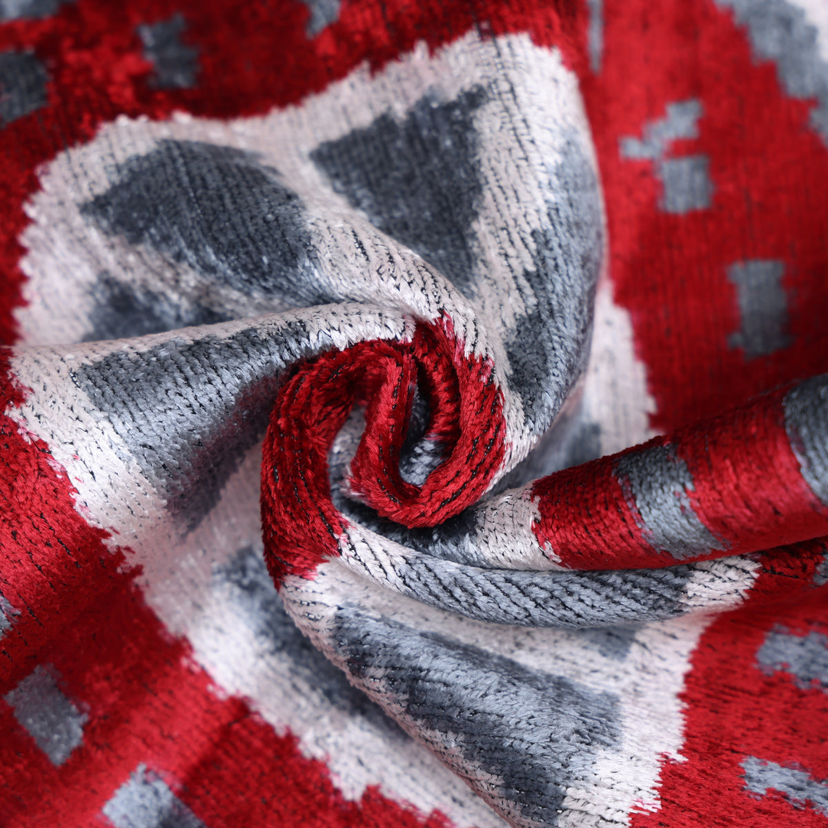 Close view of crimson red and slate gray velvet showing plush texture and changing luster