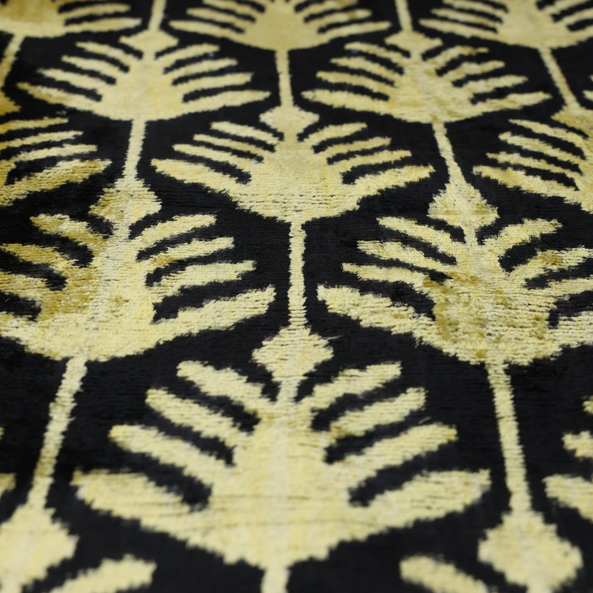 Overhead close-up of chartreuse gold and black geometric foliage motif