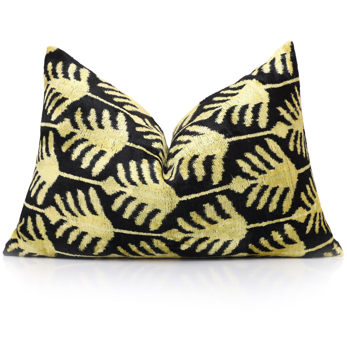 Styled front view of a chartreuse gold and black botanical lumbar pillow with a karate chop