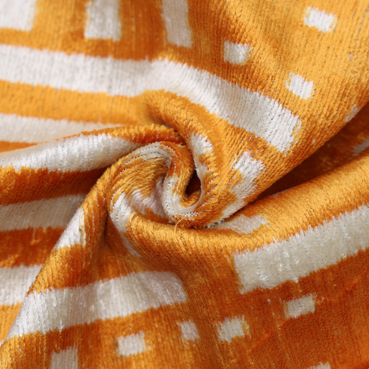 Close-up of marigold yellow and ivory white velvet weave and geometric pattern