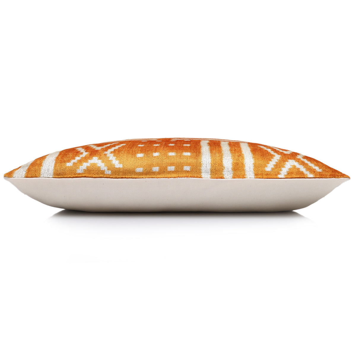 Bottom-edge side view showing the marigold yellow and ivory white pillow profile