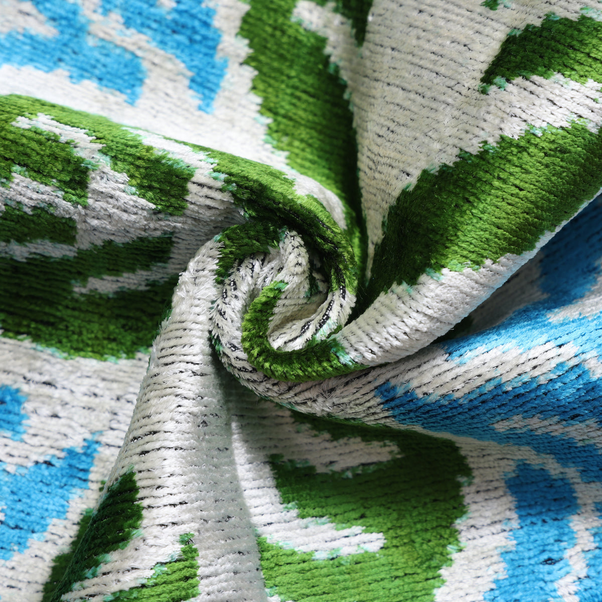 Close-up of cerulean teal silk velvet pile showing its luminous cut texture