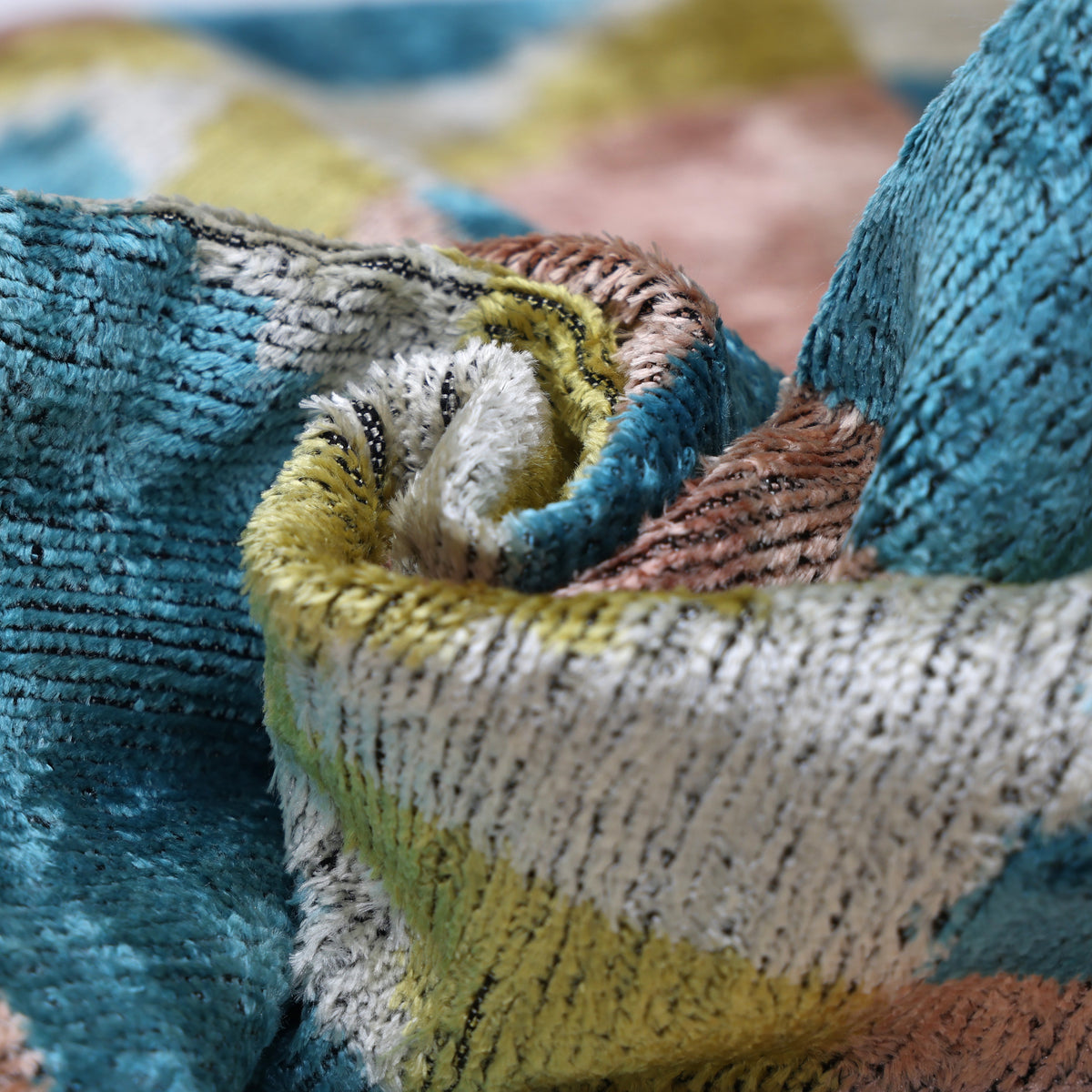 Macro view of swirled silk velvet pile in the geometric patterned surface