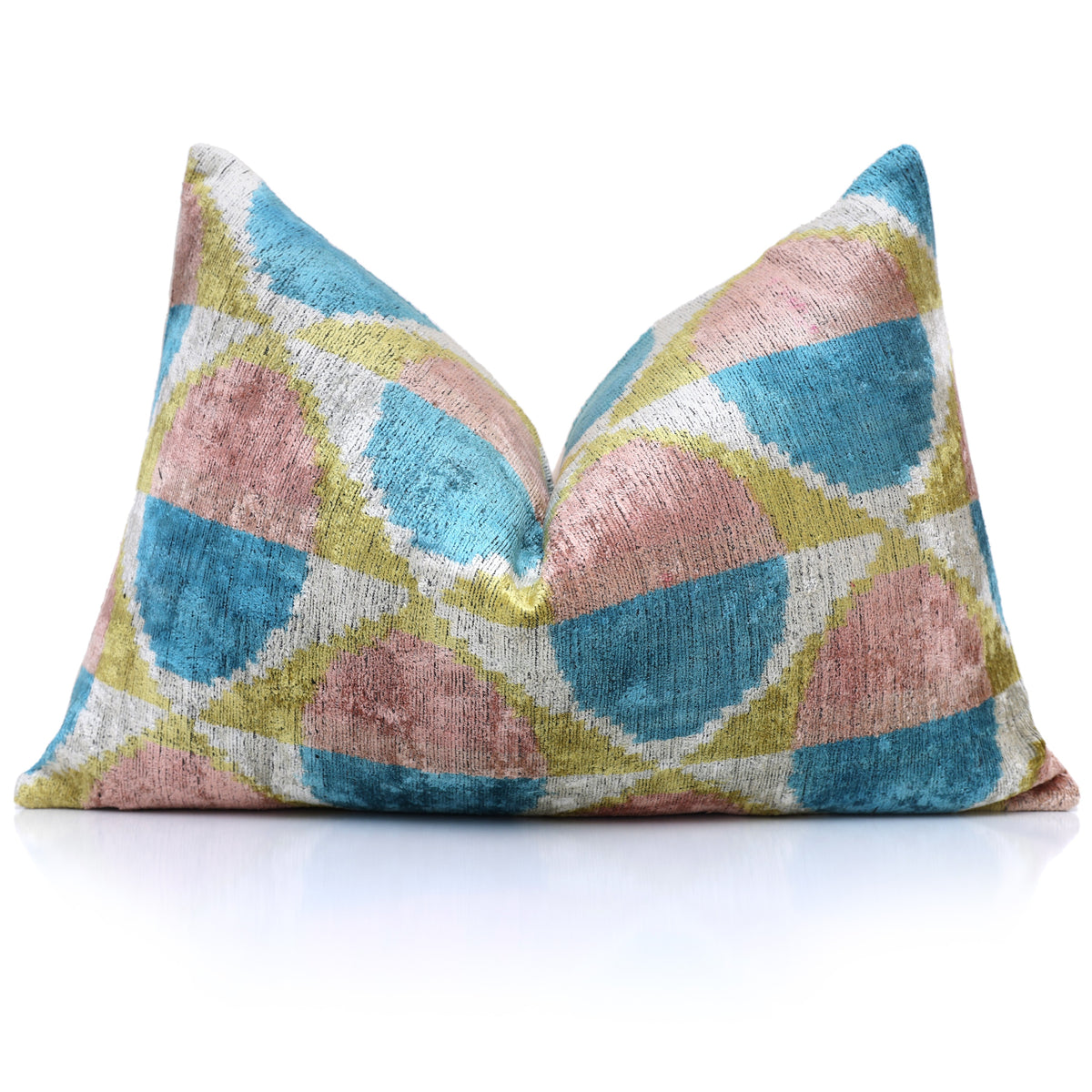 Geometric ikat lumbar pillow with a center chop styled on reflective white
