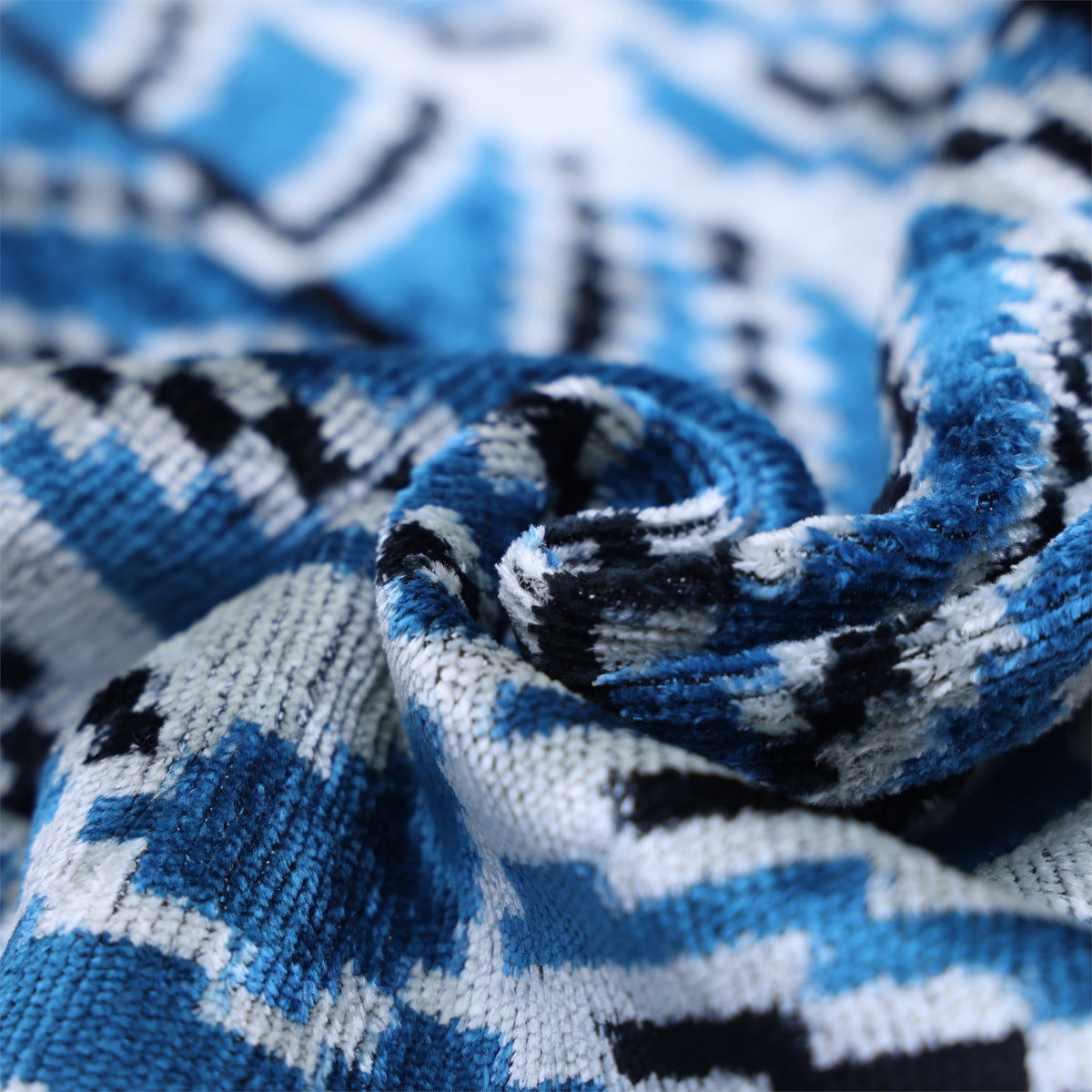 Folded cerulean blue velvet showing its soft pile and subtle sheen