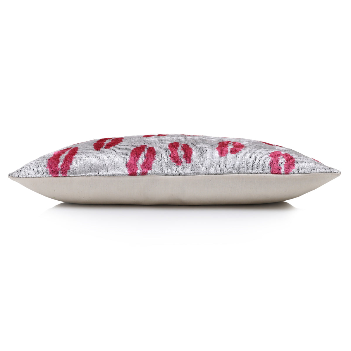 Side profile of silver gray and fuchsia pink lumbar pillow showing thickness
