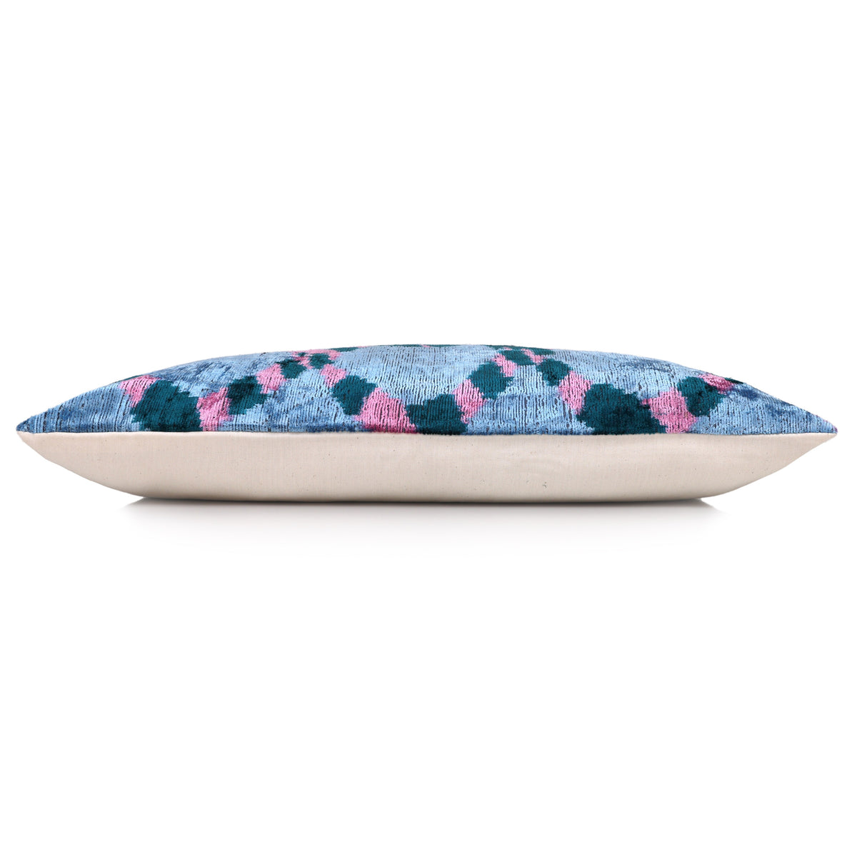 Side view of ice blue lumbar pillow with dark teal pattern and neutral backing