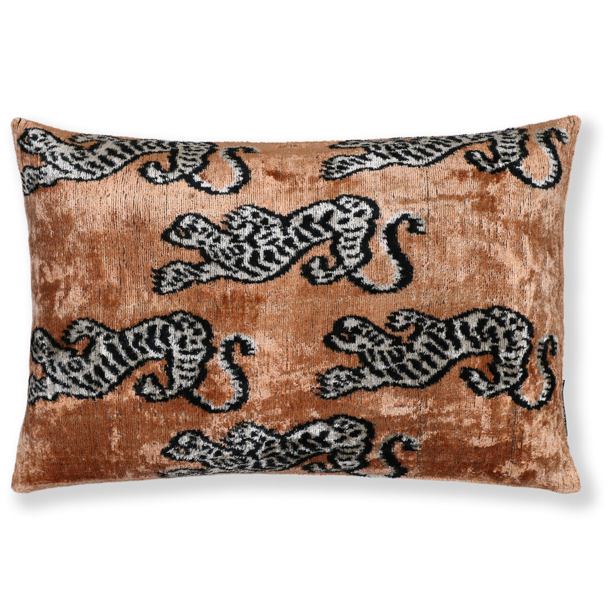 Warm camel tan lumbar pillow with black and soft white tiger motifs on the front