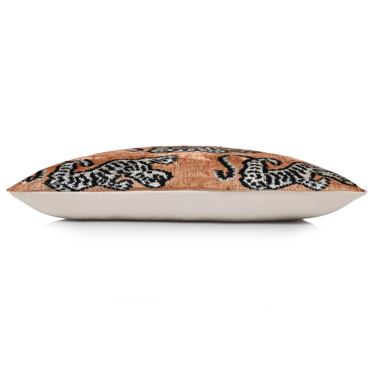 Side view of camel and black tiger lumbar pillow displaying its profile and backing