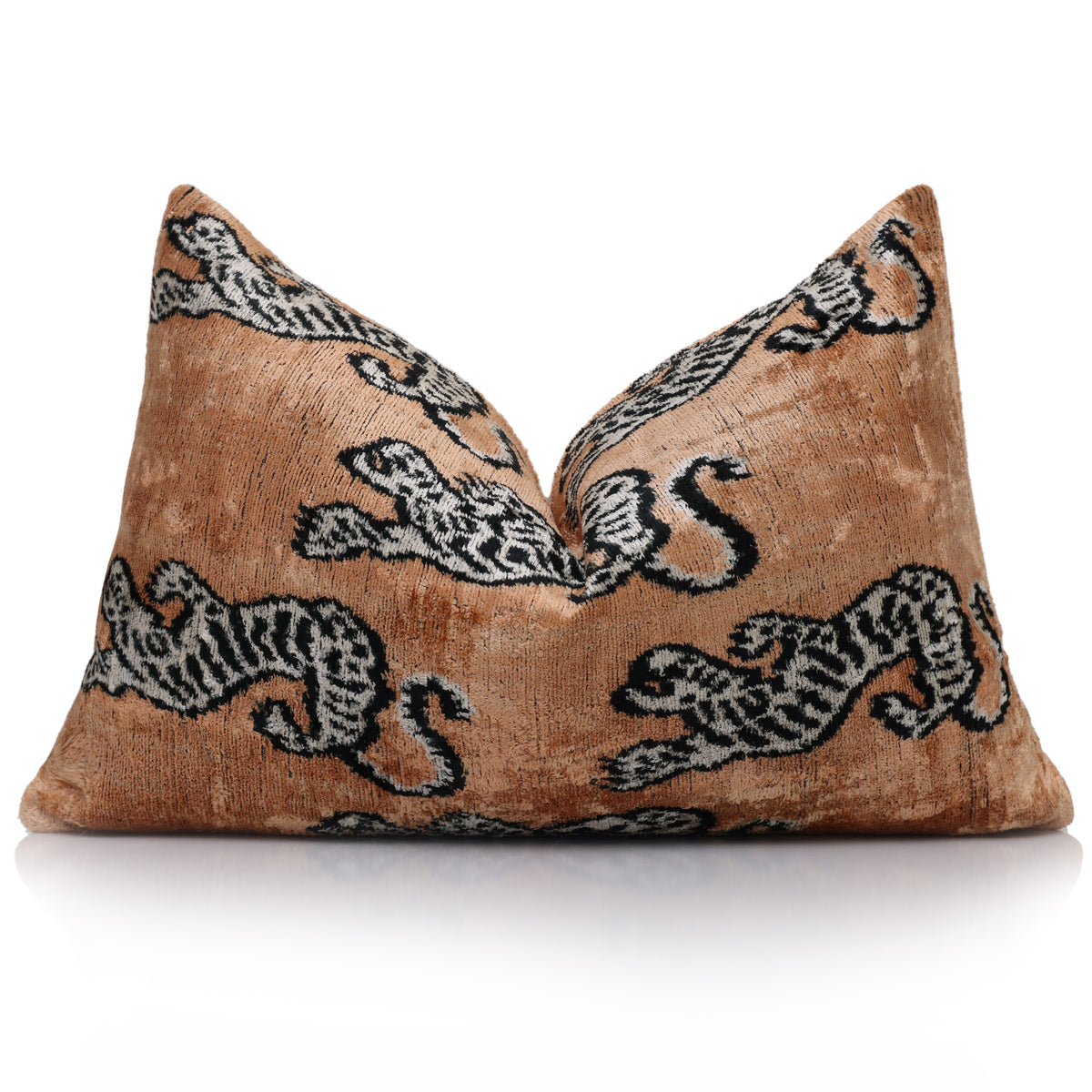 Camel tiger lumbar pillow styled upright, showing soft white and black motifs