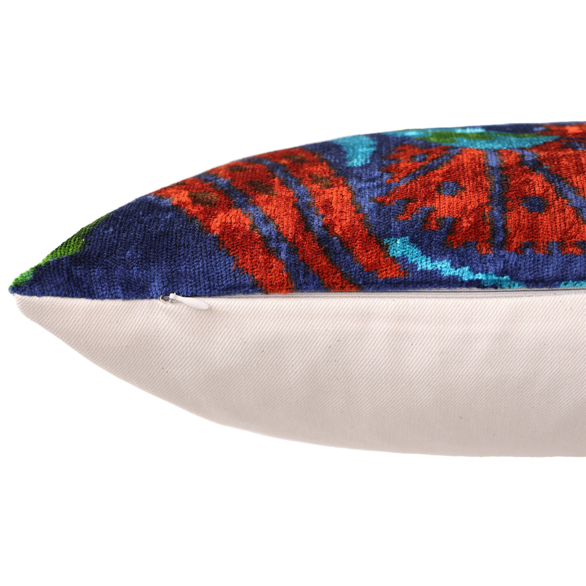 Side seam close-up showing hidden zipper on deep royal blue floral velvet pillow