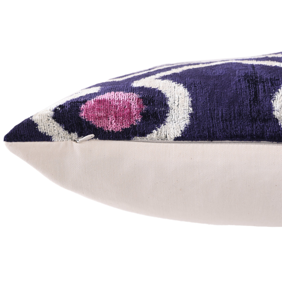 Bottom edge detail showing the hidden zipper on deep indigo purple velvet pillow