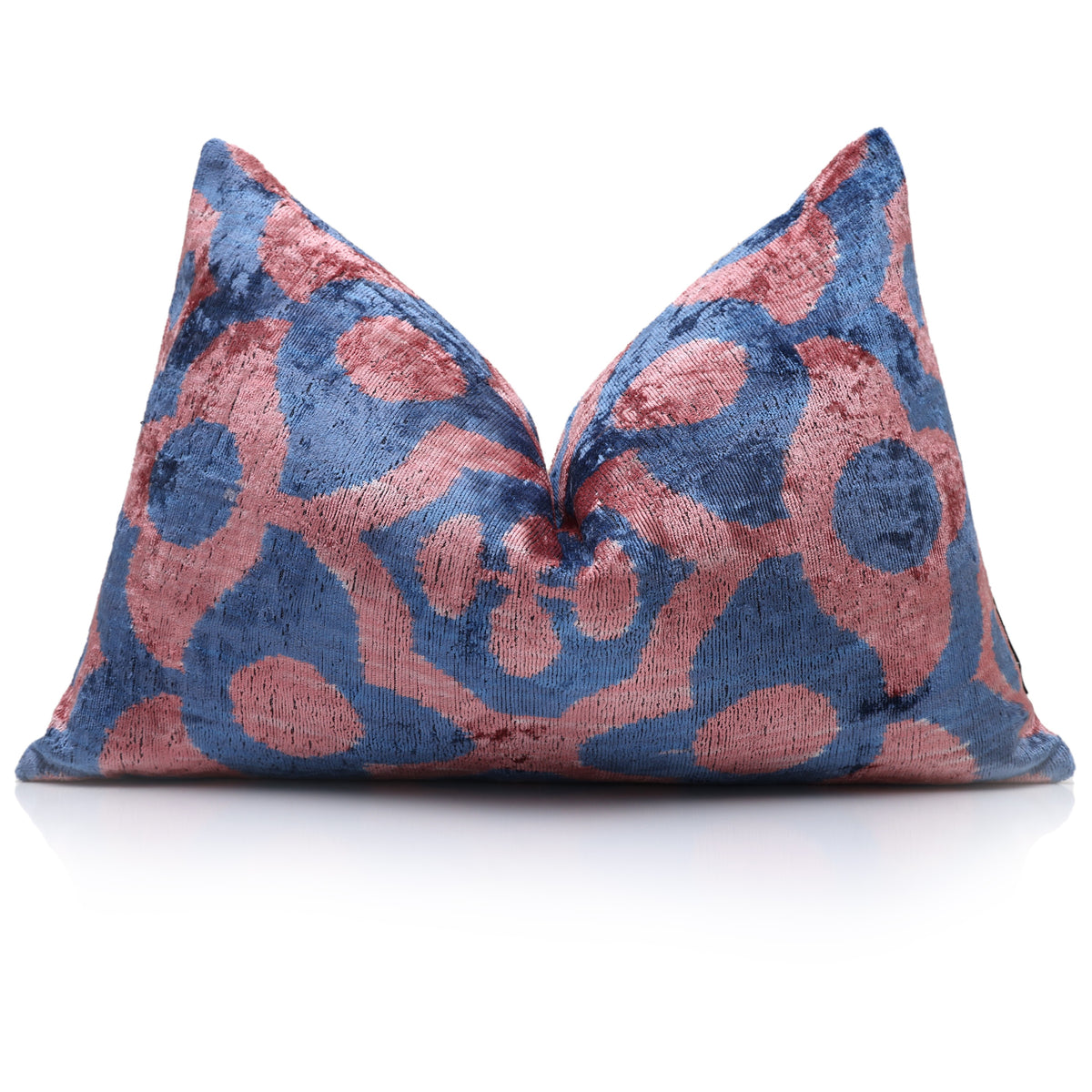 Slate blue and dusty rose pink ikat lumbar pillow styled with a karate chop