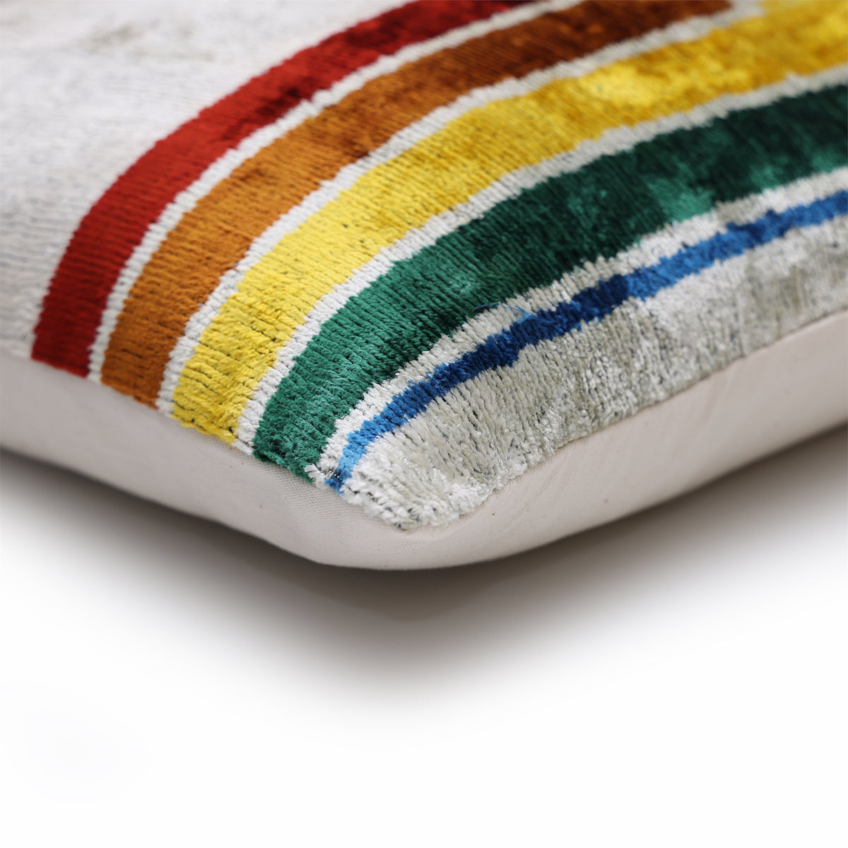 Corner detail of silvery off-white silk velvet with colorful wave stripe and reflective sheen