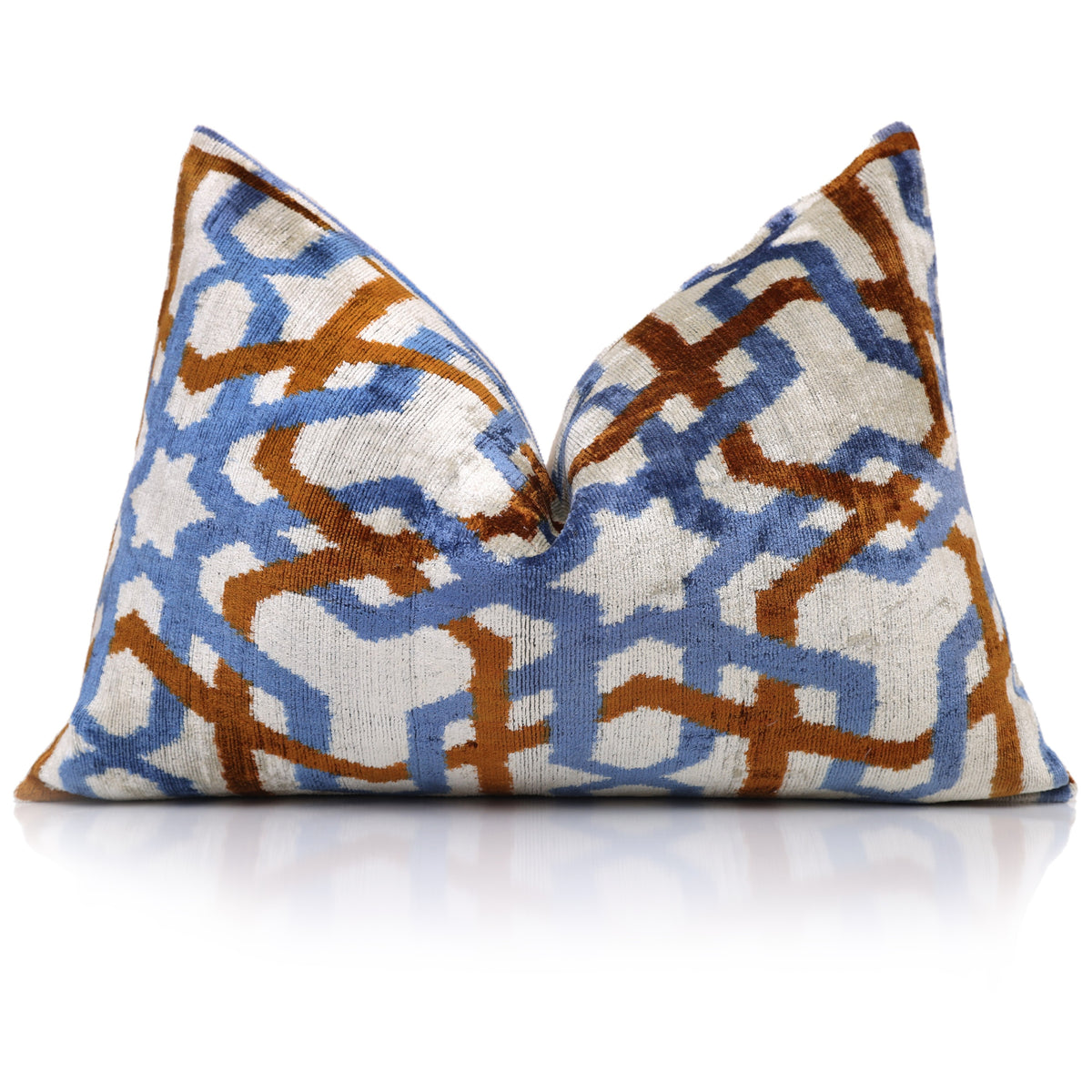 Styled pale ivory, cornflower blue and cognac rust lumbar pillow with a center karate chop