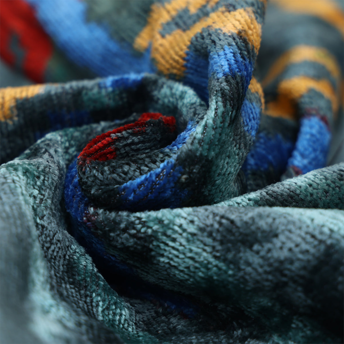 Folded dark teal velvet showing plush pile and changing sheen