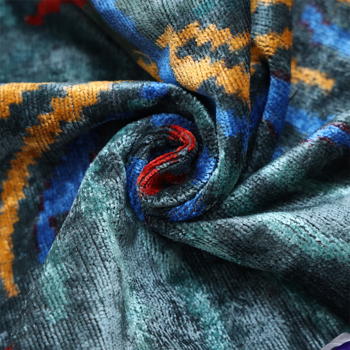 Close-up showing dark teal silk velvet pile with light and reflective luster