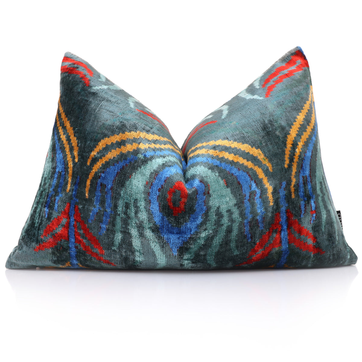 Front view of dark teal ikat lumbar pillow styled against a neutral backdrop