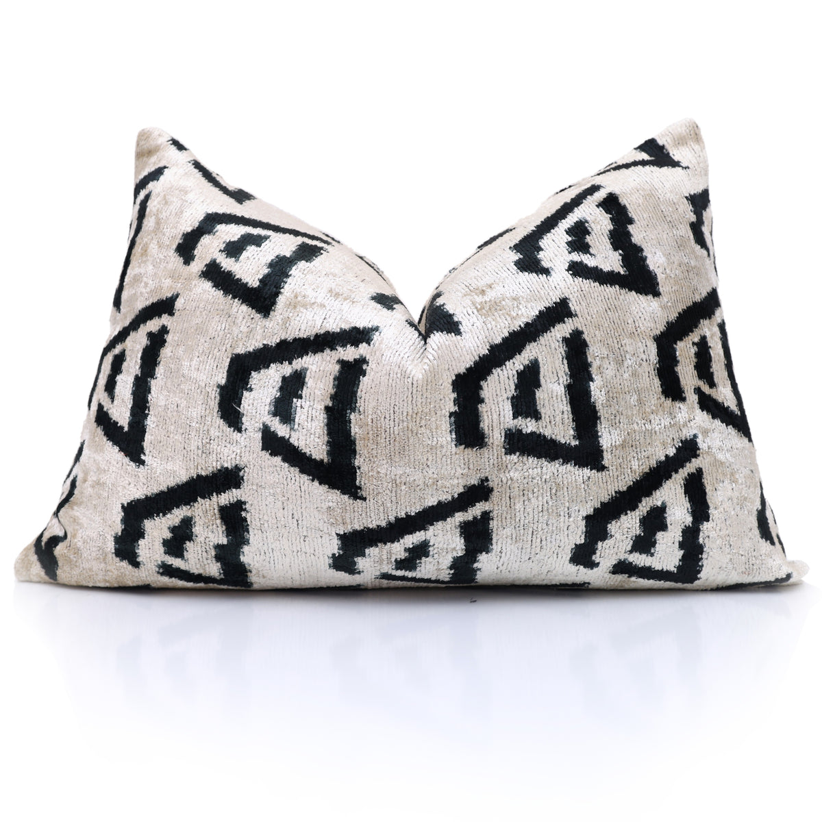 Ivory, sand beige and black geometric lumbar pillow styled with a karate chop