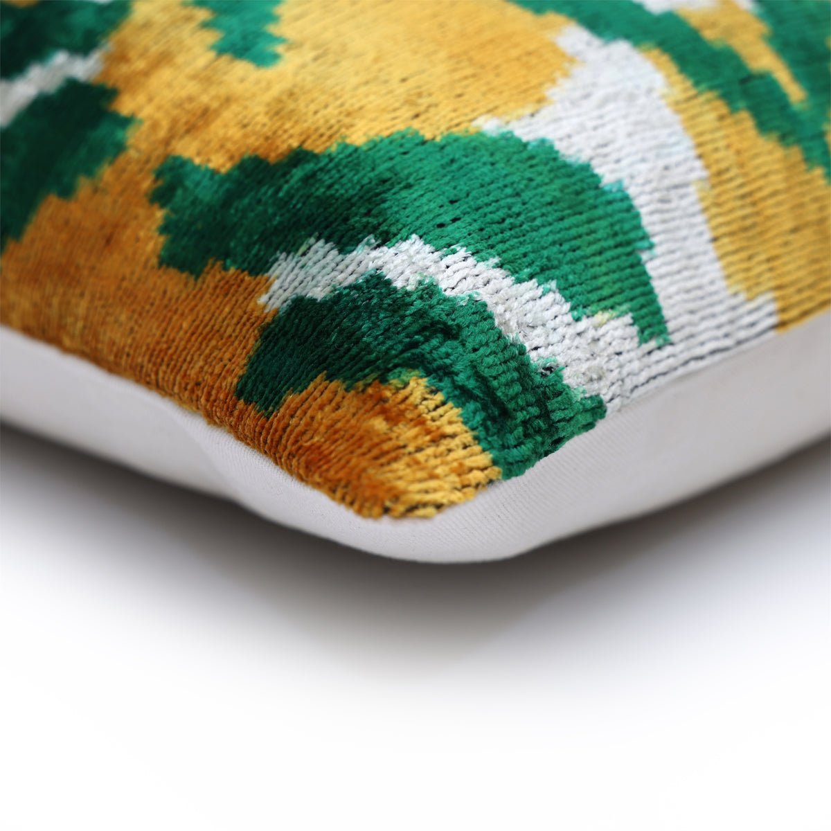 Corner detail with patterned velvet, piped edge and plain white backing