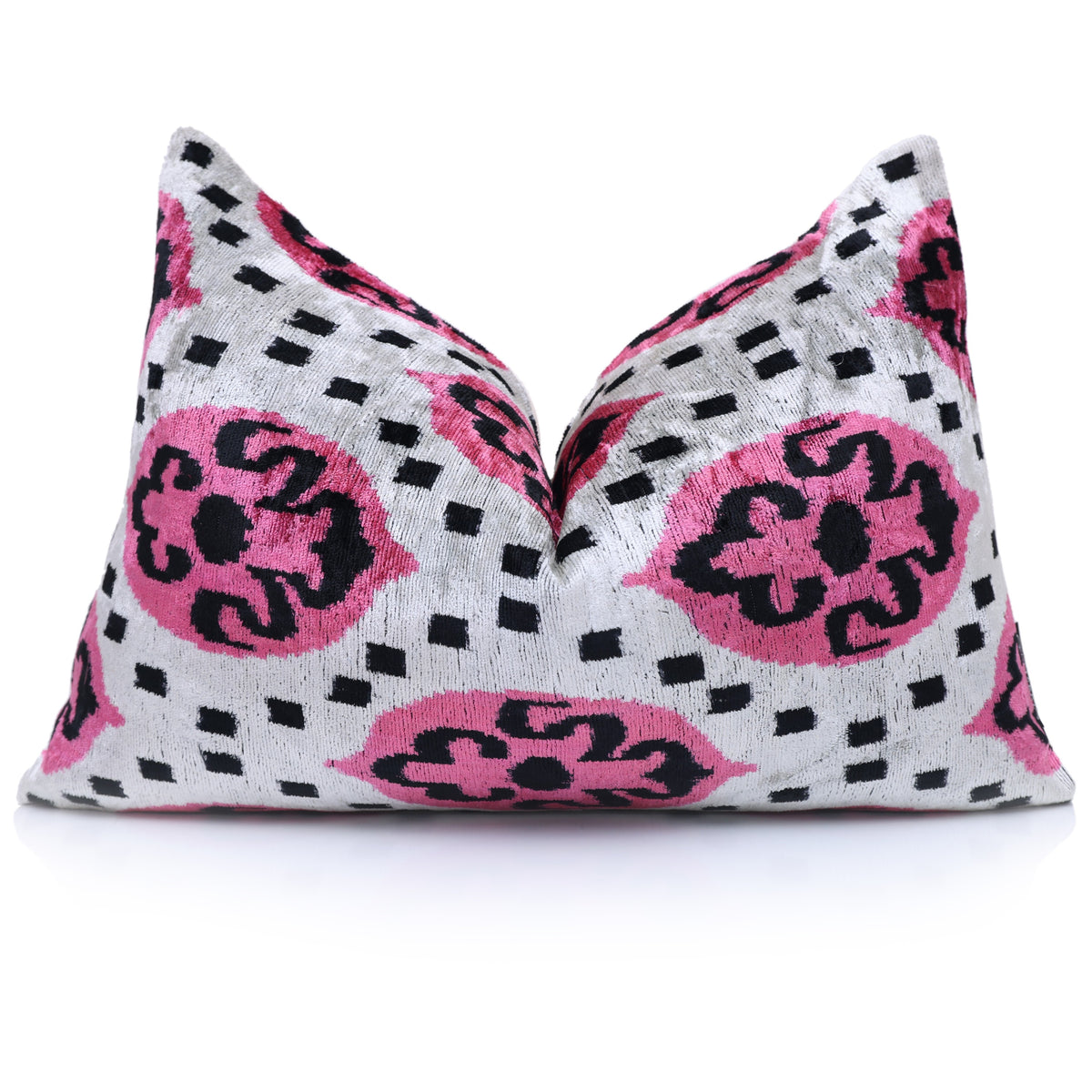 Lumbar pillow styled with a center chop, showing magenta pink and black medallions