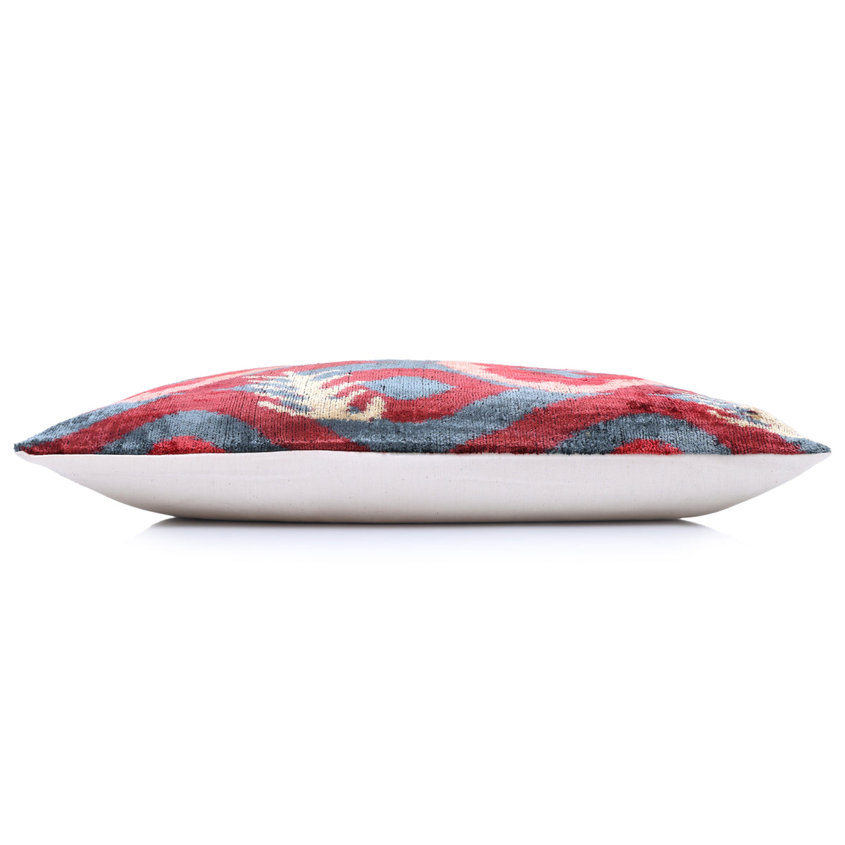 Horizontal side profile of the ikat lumbar pillow with light beige backing