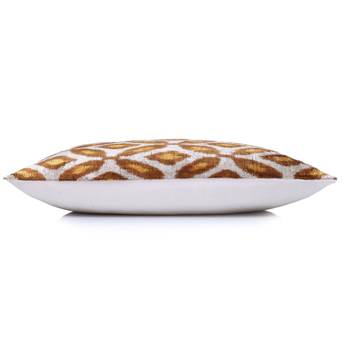 Side profile of geometric lumbar pillow showing silvery white backing and depth