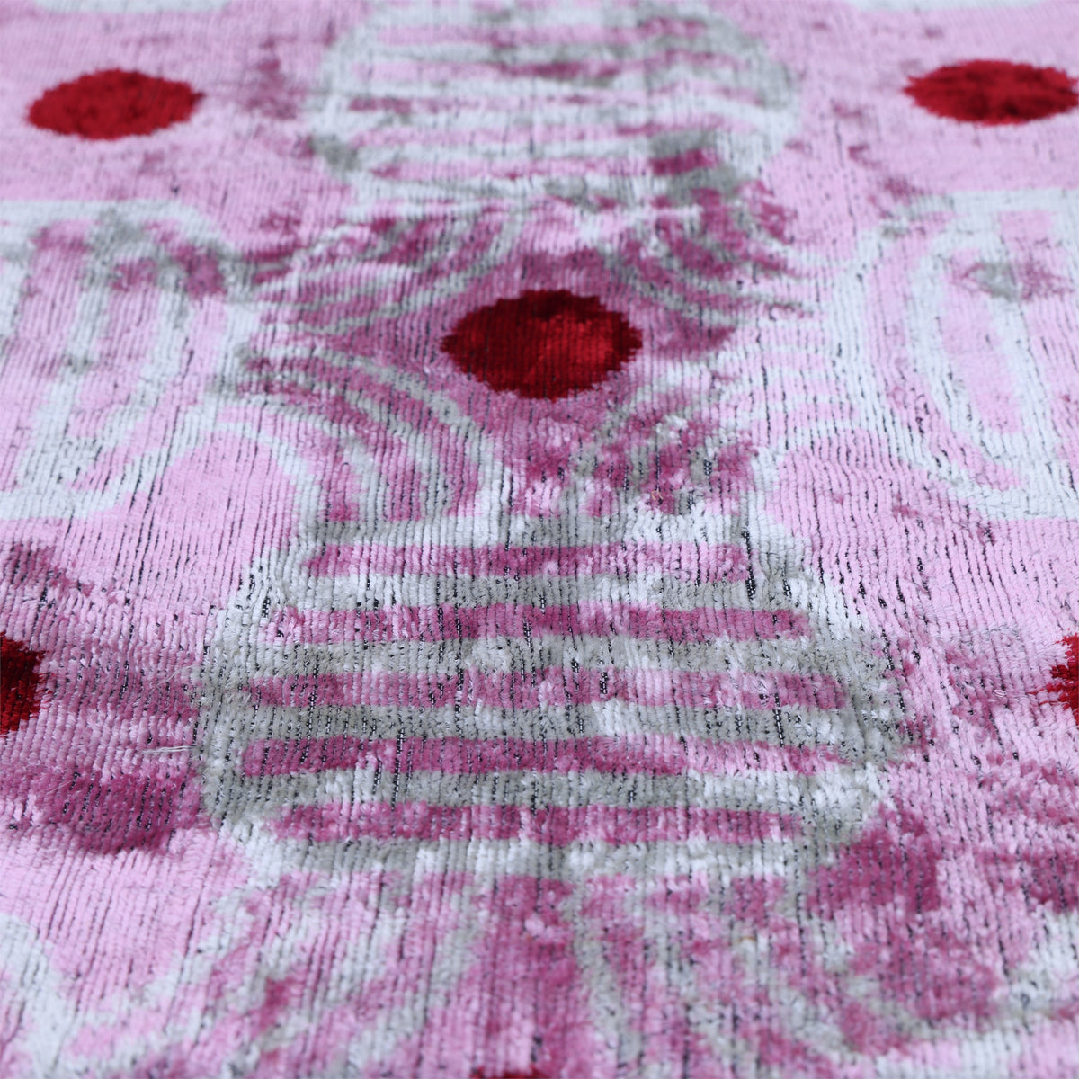 Angled surface detail of lavender pink and soft white woven velvet pile