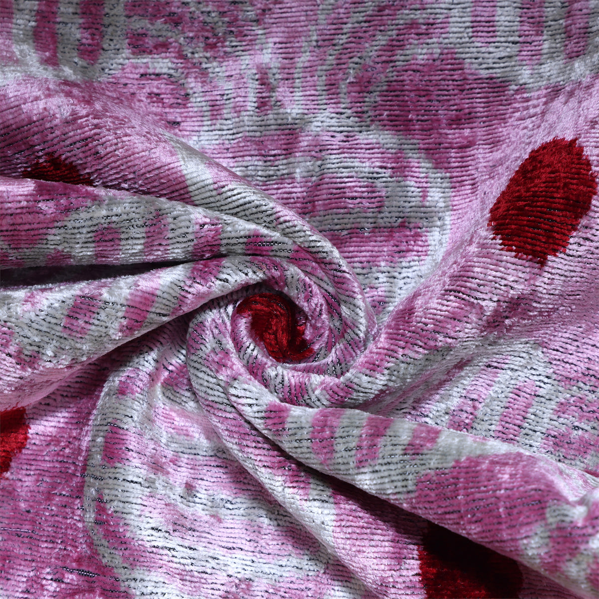 Swirled close-up of lavender pink silk velvet showing rich pile and soft sheen