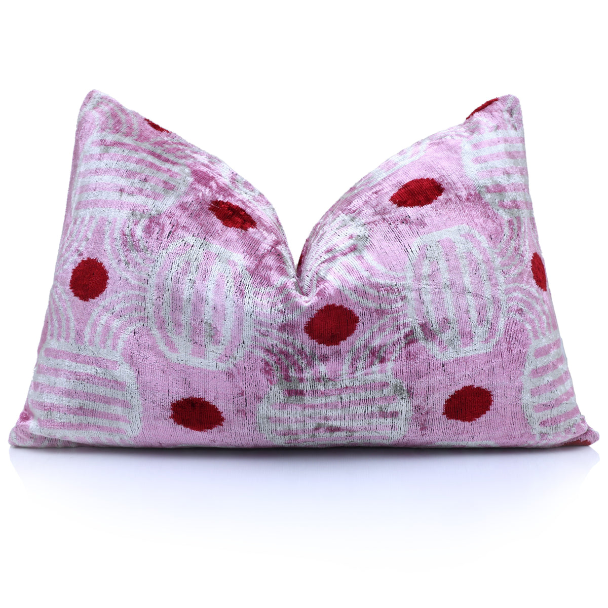 Styled lavender pink and soft white ikat lumbar pillow upright on a white background